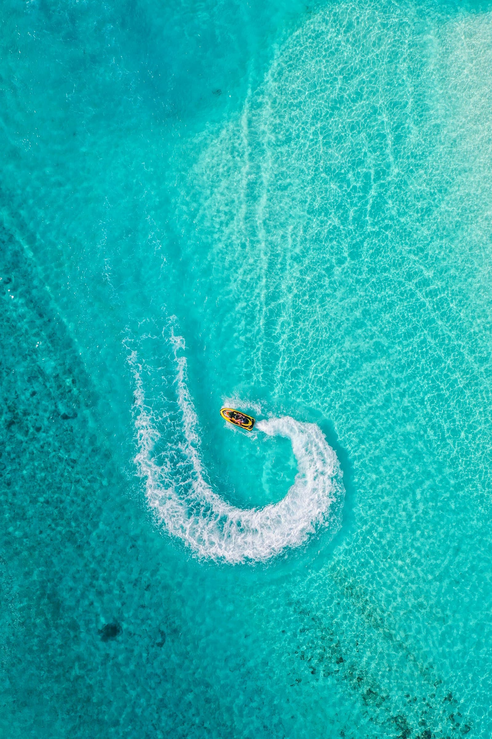 Jet ski crossing bright blue water near Koh Larn