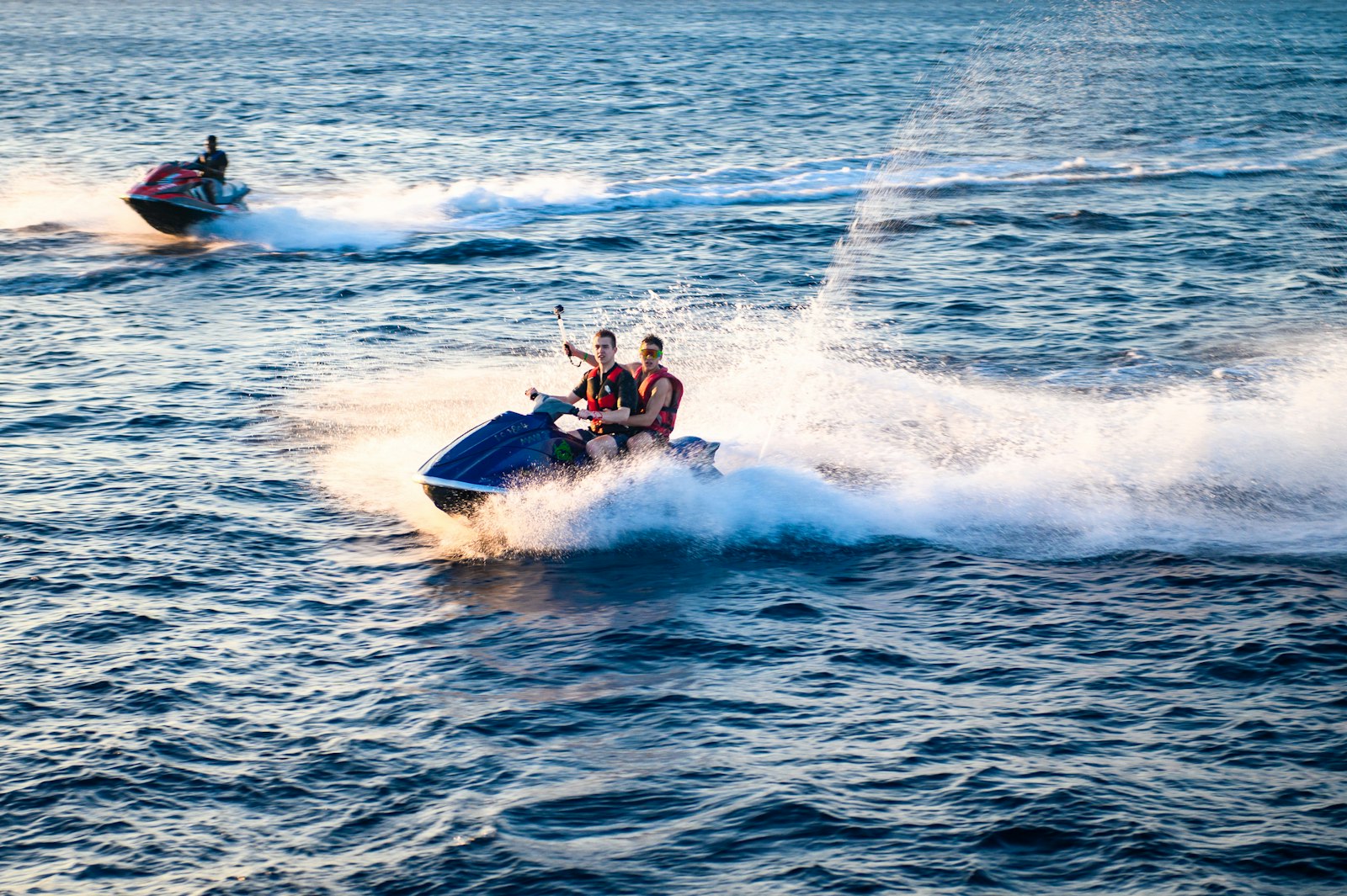 Two riders carving a turn on a jet ski