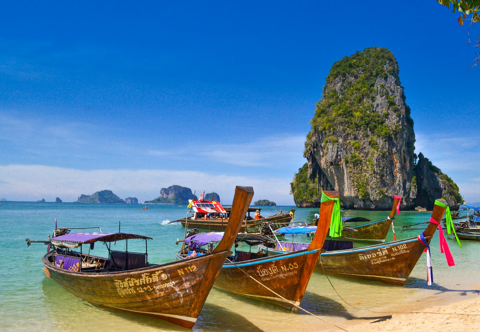 Longtail boats on a turquoise bay in Thailand