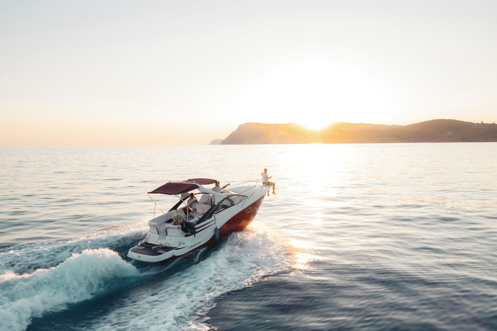 Speedboat cruising into the sunset